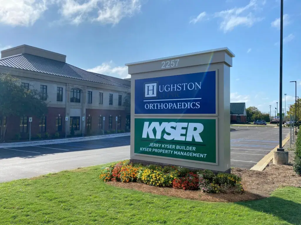 The sign and building for Hughston Clinic in Montgomery, AL