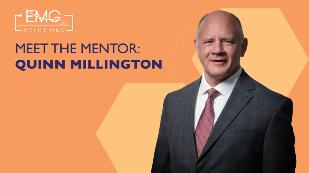 This promotional graphic from EMG Solutions features a professional headshot of Quinn Millington on the right side. He is a middle aged man with a smiling expression, wearing a dark charcoal suit jacket, a white dress shirt, and a red patterned tie. The background of the graphic is a vibrant orange color with subtle geometric hexagonal patterns in a lighter shade. On the left side, the white EMG Solutions logo appears above the bold dark blue text that reads "MEET THE MENTOR: QUINN MILLINGTON."