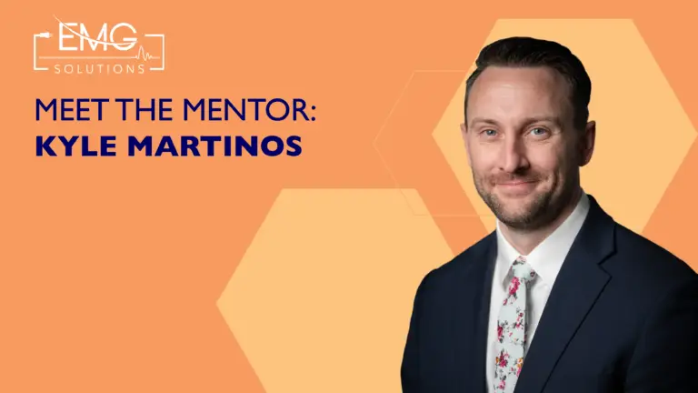 A professional promotional graphic for EMG Solutions featuring a headshot of Kyle Martinos. On the left side, the EMG Solutions logo sits above the bold, dark blue text "MEET THE MENTOR: KYLE MARTINOS." The background is a solid orange with subtle, lighter orange hexagonal patterns. On the right, Kyle Martinos, a man with short brown hair, is shown smiling and wearing a dark blue suit, white dress shirt, and a white tie with red floral patterns.